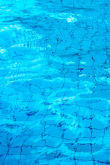 Reflection of sky on the moving water surface in the pool