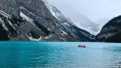 Canoeing in emerald Lake Louise by Victoria Glacier and Fairview Mountain.  Canadian Rockies in Banff National Park. Alberta. Canada.