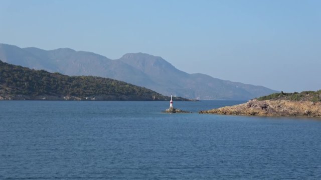 From Yacht passing Lighthouse, Beacon on Peninsula in Greece