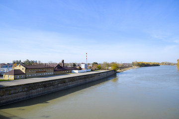 Fototapeta premium Slavyansk-na-Kubani, Russia - September 9, 2016: Autumn landscape. the river and the bridge type. Trees with yellow leaves.