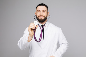 Friendly smiling medic or doctor holding stethoscope isolated on white background