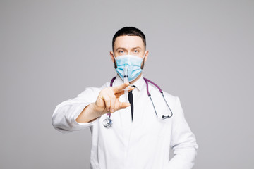 Doctor , postgraduate student in mask and medical gown holding syringe isolated on white studio background. Medicine concept