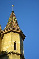 Fototapeta na wymiar Old church tower architecture detail in a sunny day with a blue sky