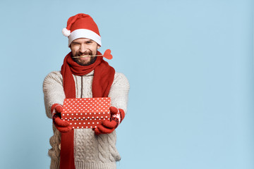 artificial heart, gift, man with a beard, light blue background, free space for copy, new year