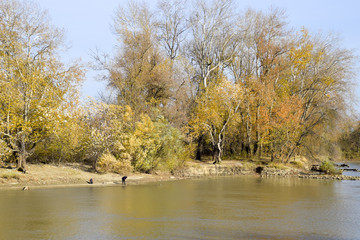 Fishermen on the bank of the river in autumn. Fishing the bait.