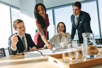 Businesswoman presenting to colleagues at a meeting