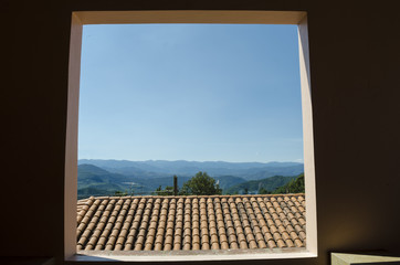 Tile roof and mountains. View from a window in Capulalpam de Mendez, magical town parto of Oaxaca, Mexico