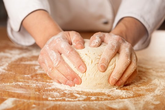 Hands Flattening the Dough