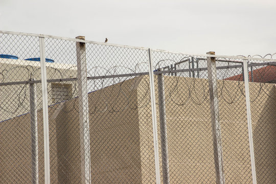 The barbed wire barrier to prevent the inmate of the prisoner.