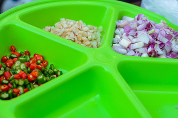 Onion, chilli, garlic on green plate