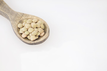 Raw lentils on wooden spoon