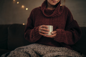 Woman having coffee in winter at home - Powered by Adobe