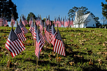 American Flags flying near a little white church on Memorial Day.