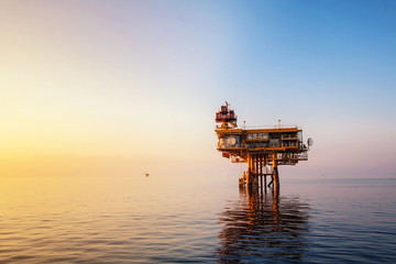 Sunset time,Offshore construction platform for production oil and gas, Oil and gas industry and hard work, Production platform and operation process by manual and auto function