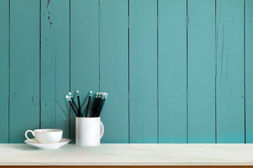 Mock up : Workspace wood desk tabletop with coffee cup and pencils. white top desk with copy space for products display montage.