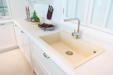 Modern, bright, clean kitchen interior with stainless steel appliances in a luxury apartment.