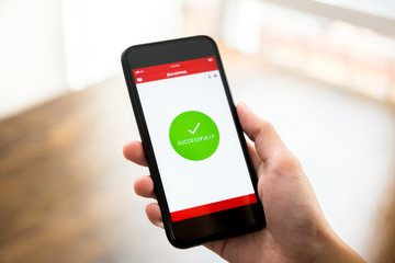 Successful online shopping confirmation sign appears in smartphone application screen