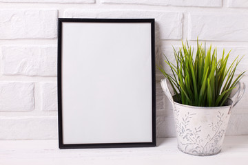 Empty frame mockup  with copy space and  grass in pot