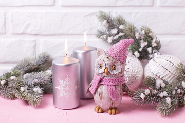 Decorative bird owl, silver candles, branches fur tree and balls