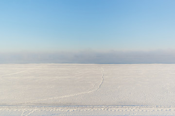 A path in the fog on the snow