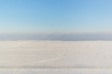 A path in the fog on the snow