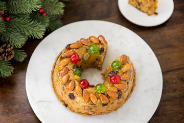 Glazed Christmas fruitcake on white plate