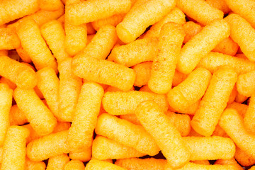 Cheese puff. Cheese puffs snack background texture food pattern. Snacks.