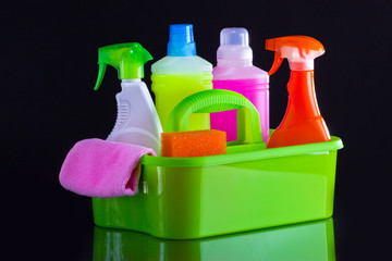 Cleaning products, home work on black background.