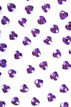 Purple rhinestone background. Heart shape texture as backdrop isolated white studio photo. Bling rhinestone crystal pattern. Rhinestones crystals as background.