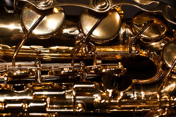 Obraz premium Fragment of saxophone in dark tones 