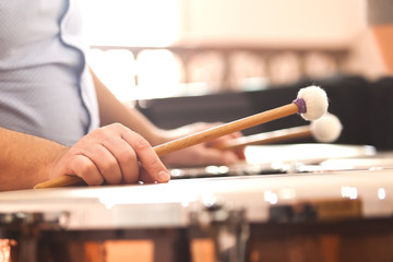 Hands musician playing the timpani closeup