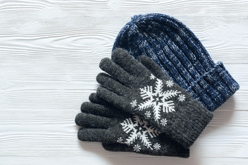 Womens winter warm accessories on white background with copy space. Woolen Knitted hat and gloves....