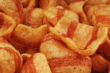 Bacon flavored snacks. Bacon chips flips background pattern texture. Food.