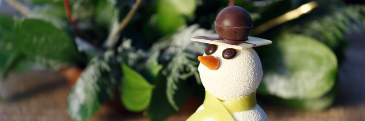 Snowman cake with Christmas decorations. Kids funny desserts and Christmas concept