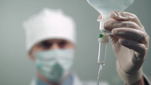 the doctor is preparing a dropper for the patient. epidemic virus covid-19