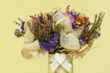 Bouquet with dried flowers in a vase with a heart.