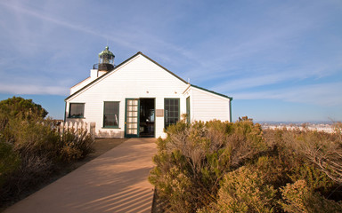 Fototapeta na wymiar OLD POINT LOMA LIGHTHOUSE AT CABRILLO NATIONAL MONUMENT UNDER BLUE CIRRUS CLOUD SKY AT POINT LOMA SAN DIEGO CALIFORNIA UNITED STATES