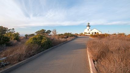 OLD POINT LOMA LIGHTHOUSE AT CABRILLO NATIONAL MONUMENT UNDER BLUE CIRRUS CLOUD SKY AT POINT LOMA SAN DIEGO CALIFORNIA UNITED STATES