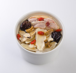 Chicken and herb soup in pot, Chinese food style.