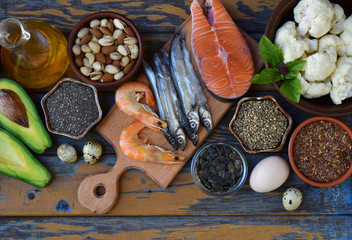 Composition of products containing unsaturated fatty acids Omega 3 - fish, nuts, avocado, eggs, soybeans, flax, pumpkin seeds, chia, hemp, cauliflower, dill, vegetable oil. Top view. Healthy food