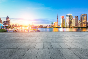 Empty square floor and with cityscape and skyline at sunset in Shanghai,China