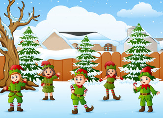 Happy kid wearing elf costume in the snowing village