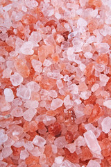 Himalayan pink rose colored natural salt. Himalayan salt crystals texture pattern as background. Healthy salt from Himalayas. Rose salt.