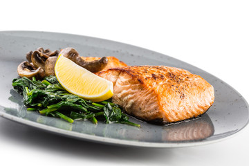 Salmon Roast Fillet. Portion of roast salmon fillet with spinach mushrooms isolated on white background