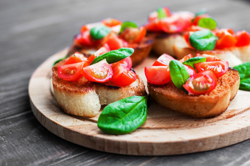 Traditional Italian bruschetta with tomatoes and spinach