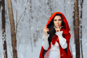 Snow Princess in Red Cape Keeping a Secret in Winter Fairy Tale