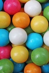 Bubble gum chewing gum texture. Rainbow multicolored gumballs chewing gums as background. Round sugar coated candy dragee bubblegum texture. Food photography. Colorful bubblegums wallpaper. Sweets.