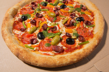 Italian pizza on a cardboard box, photo on a wide-angle lens
