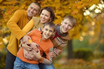 Fototapeta premium smiling family in autumn forest 
