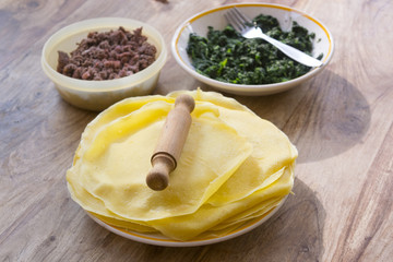 preparing meat and spinach crepes